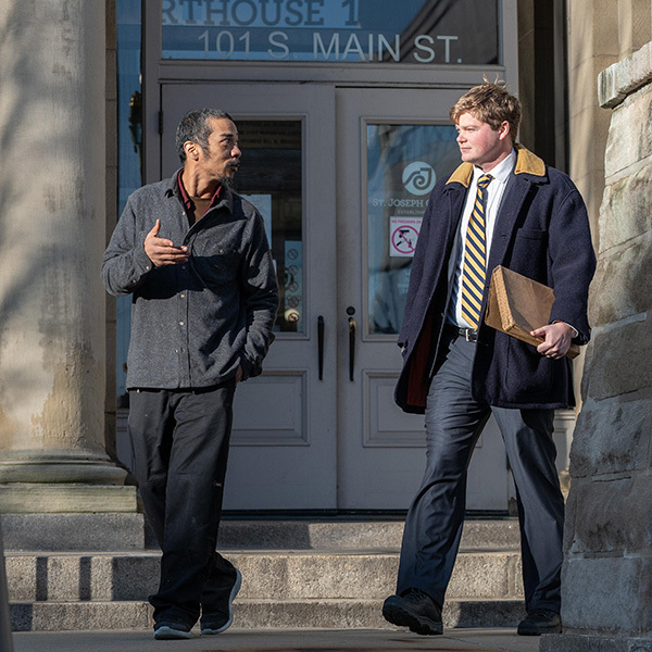 ND Law 3L Nate Barry walking with his client, Noah Jeffcoat