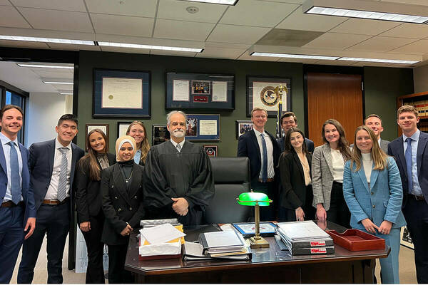 Notre Dame Law students standing with Judge John Robert Blakey