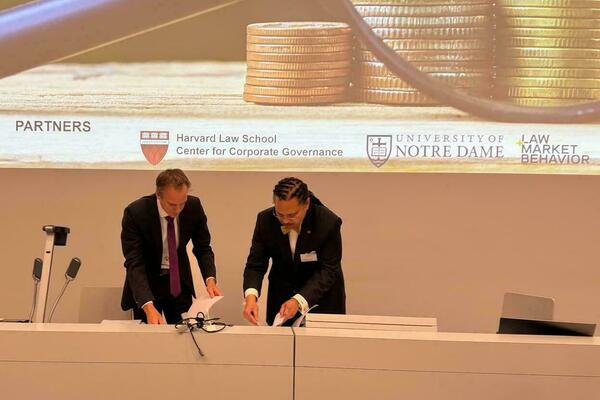 University of Lucerne's Nicolas Diebold shaking hands with ND Law Dean Marcus Cole