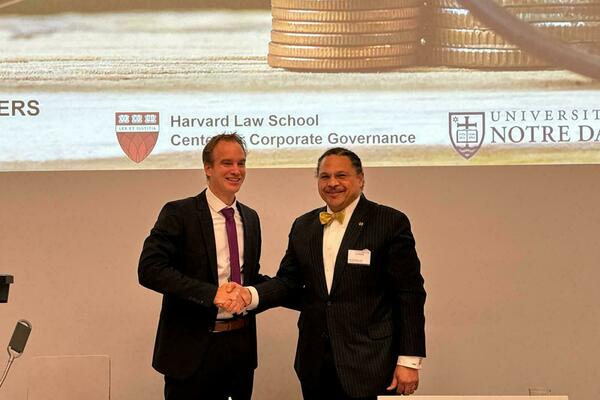 University of Lucerne's Nicolas Diebold shaking hands with ND Law Dean Marcus Cole