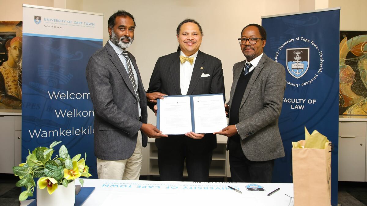 ND Law Dean Marcus Cole, UCT Faculty of Law Dean Danwood Chirwa, and UCT Vice Chancellor Jeff Murugan standing with the MOU