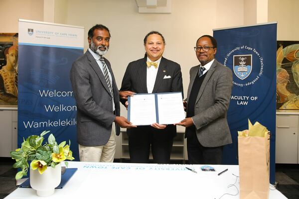ND Law Dean Marcus Cole, UCT Faculty of Law Dean Danwood Chirwa, and UCT Vice Chancellor Jeff Murugan standing with the MOU
