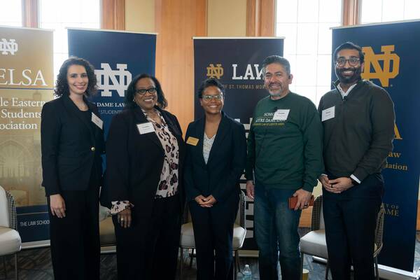 Ayah, Cynthia Hardy, Gillian Harris and Devan Patel smile at a Notre Dame Law School event.
